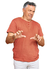Handsome middle age man wearing casual clothes disgusted expression, displeased and fearful doing...