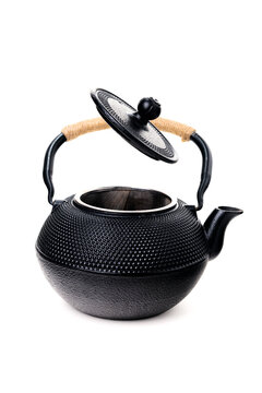 Traditional black asian cast iron kettle with open lid isolated on white background