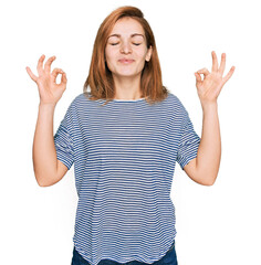 Young caucasian woman wearing casual clothes relax and smiling with eyes closed doing meditation gesture with fingers. yoga concept.