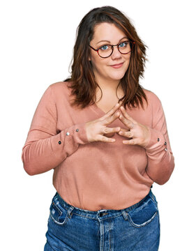 Young plus size woman wearing casual clothes and glasses hands together and fingers crossed smiling relaxed and cheerful. success and optimistic