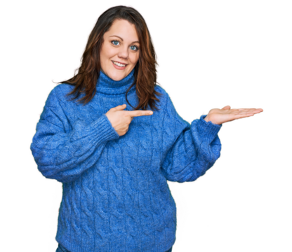 Young plus size woman wearing casual clothes amazed and smiling to the camera while presenting with hand and pointing with finger.