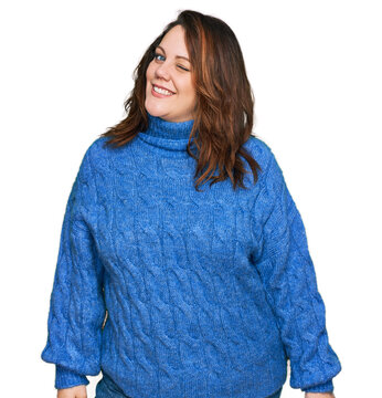 Young plus size woman wearing casual clothes winking looking at the camera with sexy expression, cheerful and happy face.