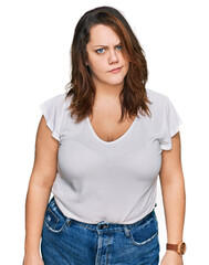Young plus size woman wearing casual white t shirt skeptic and nervous, frowning upset because of problem. negative person.