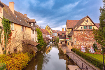 Traditional Alsatian half-timbered houses, church and river Lauch, Colmar, Alsace, France - obrazy, fototapety, plakaty