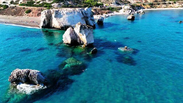 Aerial Panning Scenic Shot Of Rock Formations In Sea At Beach On Sunny Day - Paphos, Cyprus