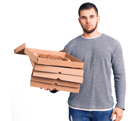Young handsome man holding delivery italian pizza boxes thinking attitude and sober expression looking self confident