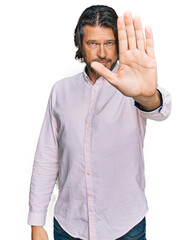 Middle age handsome man wearing business shirt doing stop sing with palm of the hand. warning expression with negative and serious gesture on the face.