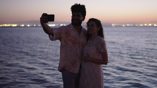 Couple takes a flash photo in the sea in Valencia