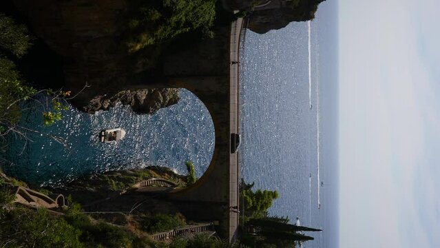 Vertical scenery view of Fjord Furore Bridge and Mediterranean sea, unusual beautiful hidden place in province of Salerno in Campania region, on sunny summer day. Shooting in slow motion.