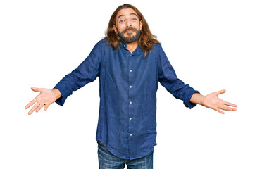 Attractive man with long hair and beard wearing casual clothes clueless and confused expression...