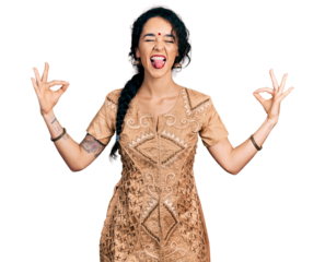 Young indian woman doing gyan mudra sticking tongue out happy with funny expression.