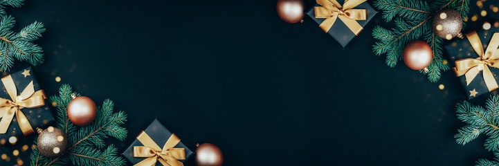 Banner with golden Christmas balls, gifts and decorations on black background with bokeh lights....