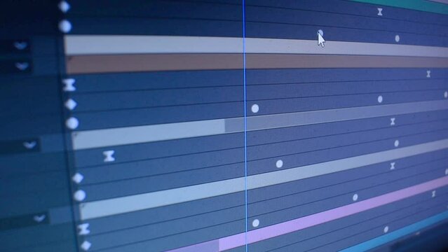 Dolly tracking shot of a computer screen in video editing software. Moving keyframes of film. Low depth of field. 