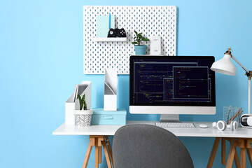 Programmer's workplace with computer and devices in office