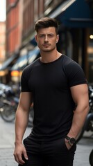 Fototapeta premium Male model in a classic black cotton T-shirt on a city street