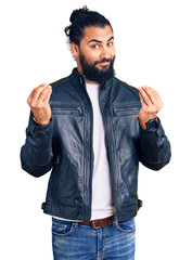 Young arab man wearing casual leather jacket doing money gesture with hands, asking for salary...