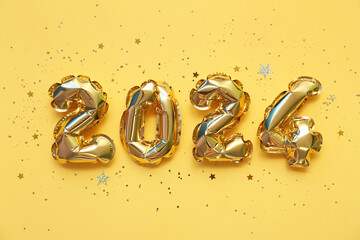 Figure 2024 made of balloons and confetti for Christmas celebration on beige background