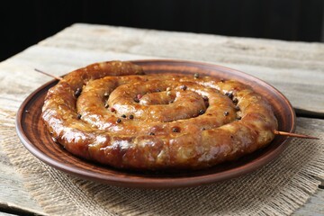 Plate with tasty homemade sausages on table, closeup