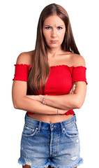 Young beautiful hispanic woman wearing casual clothes skeptic and nervous, disapproving expression...