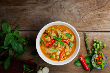Chicken green curry Asian food, Beef green curry Thai food on a soup bowl with a mixture of herbs, vegetables and Thai red chilli spices. Top view.