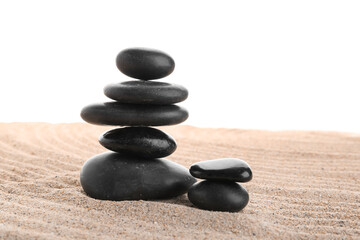 Pyramid of black stones on the sand isolated on a white background
