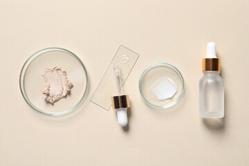 Bottle of cosmetic serum and petri dishes with samples on beige background, flat lay