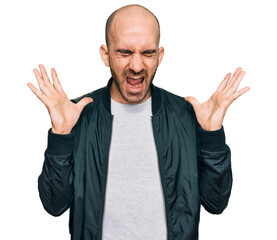 Young hispanic man wearing casual clothes celebrating mad and crazy for success with arms raised...