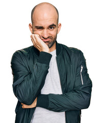 Young hispanic man wearing casual clothes thinking looking tired and bored with depression problems with crossed arms.