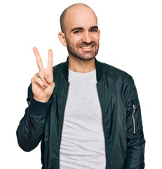 Young hispanic man wearing casual clothes showing and pointing up with fingers number two while smiling confident and happy.