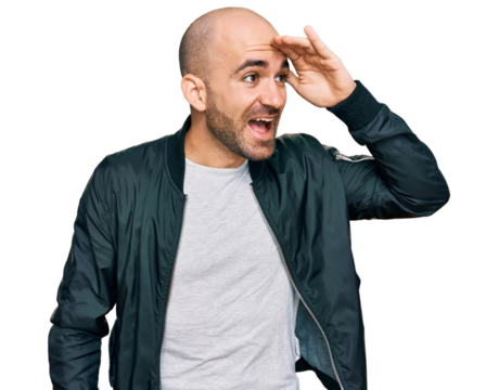 Young hispanic man wearing casual clothes very happy and smiling looking far away with hand over head. searching concept.