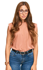 Young hispanic woman wearing casual clothes and glasses looking sleepy and tired, exhausted for...