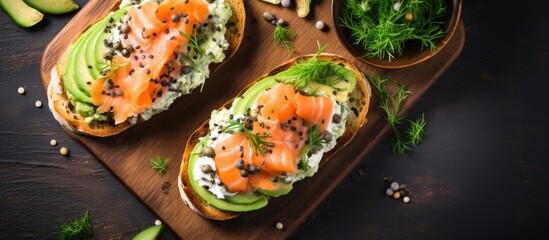 Top view of avocado and salmon toasts made with sourdough bread, cream cheese, and seeds. - obrazy, fototapety, plakaty