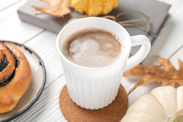 Cup of aromatic coffee on light wooden table, closeup