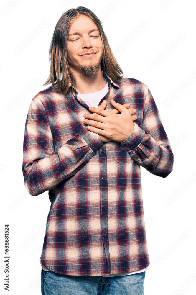 Poster handsome caucasian man with long hair wearing hipster shirt smiling with hands on chest with closed 