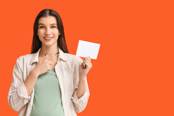 Woman with voting paper on orange background
