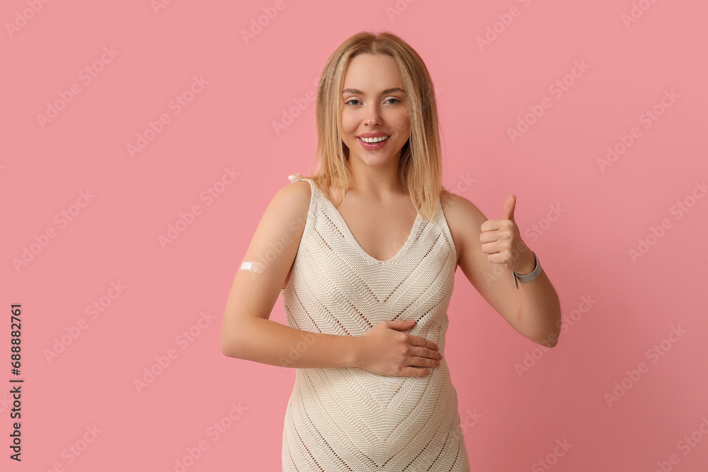 Canvas Prints Young pregnant woman after vaccination showing thumb-up on pink background