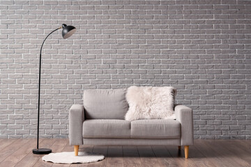 Interior of living room with grey sofa and floor lamp