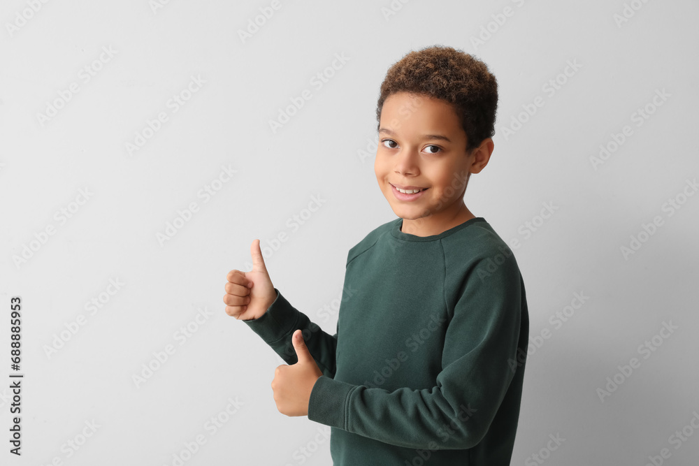 Sticker little african-american boy showing thumbs-up on white background