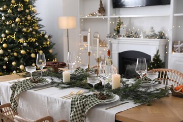 Christmas table setting with festive decor and dishware in living room
