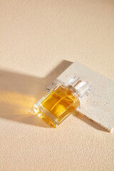Photos for professional advertising with perfume products. A glass bottle filled with yellow liquid...