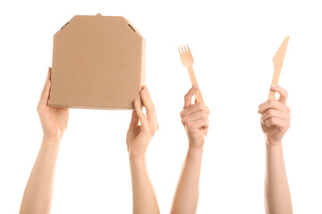 Female hands with takeaway cardboard pizza box and cutlery on white background