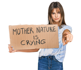 Teenager caucasian girl holding mother nature is crying protest cardboard banner pointing with finger to the camera and to you, confident gesture looking serious
