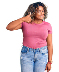 Young african american plus size woman wearing casual clothes doing happy thumbs up gesture with hand. approving expression looking at the camera showing success.