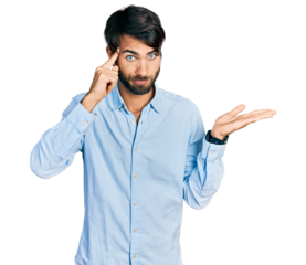 Hispanic man with blue eyes wearing business shirt confused and annoyed with open palm showing copy space and pointing finger to forehead. think about it.