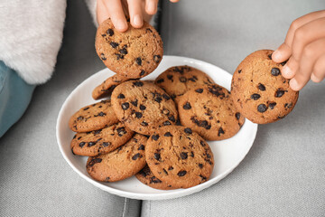 Little children eating cookies at home