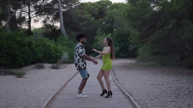 Long choreography of a couple of bachata dancers in the countryside