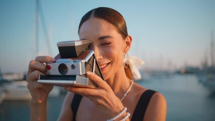Carefree traveler photographing seaside with yachts summer evening close up.