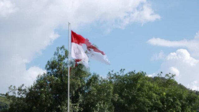 hyperlapse of clouds and the red and white flag of the Republic of Indonesia