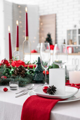 Festive table setting with Christmas decorations in kitchen, closeup