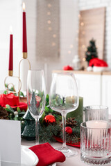 Empty champagne glasses with Christmas decorations on festive served table, closeup